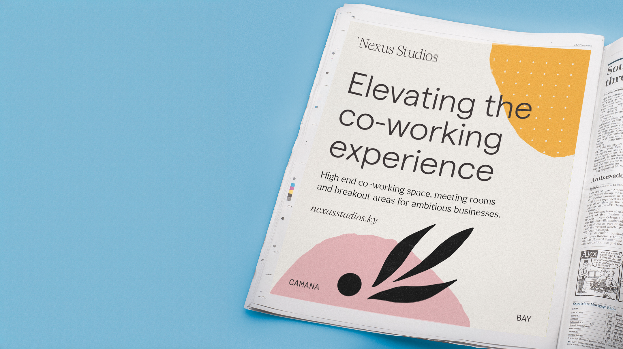 The image shows an open newspaper with an advertisement for Nexus Studios prominently displayed on the left page. The ad features a clean and modern design with the headline "Elevating the co-working experience" in large, bold serif font. Below the headline, a smaller text describes Nexus Studios as a "High end co-working space, meeting rooms and breakout areas for ambitious businesses." and includes a website address. A graphic design on the ad consists of a black stylized leaf motif on pink and a partial abstract shape in golden yellow with a white dotted pattern, both situated near the bottom edge of the page. The names "CAMANA BAY" are visible, hinting at the location. The overall design of the ad is elegant and visually appealing, intended to attract business professionals.