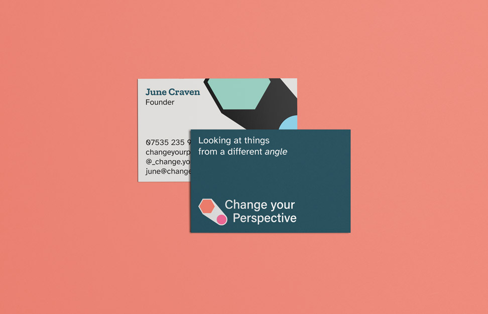 wo business cards for Change Your Perspective, one showing the logo and tagline 'Looking at things from a different angle' on a teal background, and the other displaying contact details for June Craven, Founder, against a geometric design on an off-white background. Both cards are displayed on an orange surface.